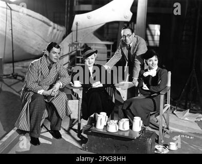 BARRY MacKAY Unidentified Female Set Visitor Director SONNIE HALE and JESSIE MATTHEWS on set candid during filming of GANGWAY 1937 director SONNIE HALE producer Michael Balcon Gaumont British Picture Corporation / General Film Distributors (GFD) Stock Photo