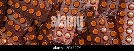 Small round tablets pills in brown blister pack. Prescription drugs. Pharmaceutical industry. Pharmacy banner. Health care and medicine concept. Pill Stock Photo