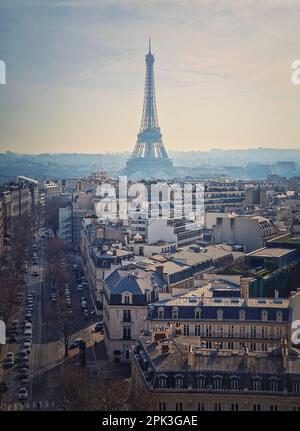 Paris cityscape with view to the Eiffel Tower, France. Beautiful parisian architecture with historic buildings, landmarks and busy city street. Aerial Stock Photo