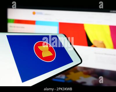 Mobile phone with flag of Association of Southeast Asian Nations (ASEAN) on screen in front of website. Focus on center-left of phone display. Stock Photo