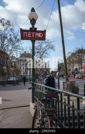 Red Metro sign and entrance in Paris, France. March 24, 2023. Stock Photo