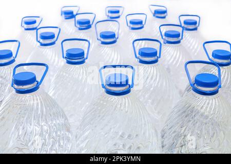 Water in plastic bottles on a white background, isolated Stock Photo