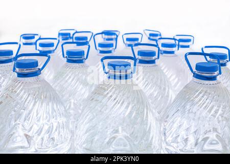 Water in plastic bottles on a white background, isolated Stock Photo
