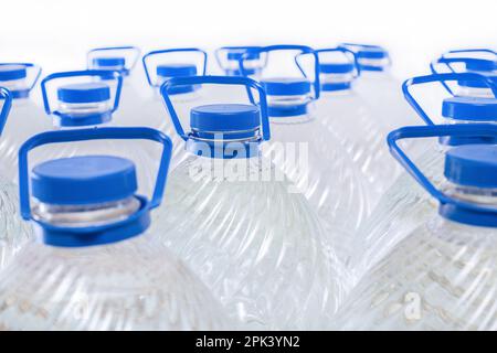 Water in plastic bottles on a white background, isolated Stock Photo