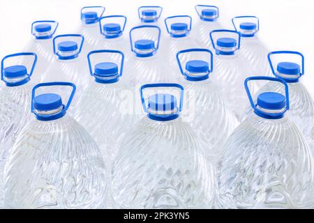 Water in plastic bottles on a white background, isolated Stock Photo