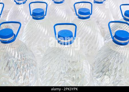 Water in plastic bottles on a white background, isolated Stock Photo