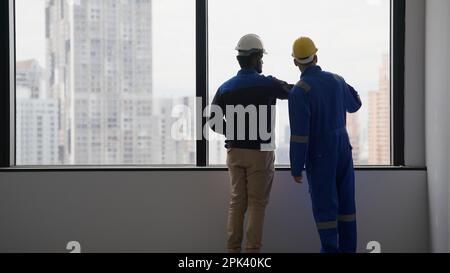 Professional construction workers using tablet brainstorming and planing Stock Photo
