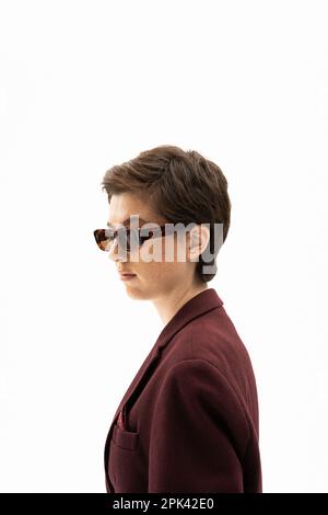 side view of woman with short brunette hair wearing trendy sunglasses isolated on white,stock image Stock Photo