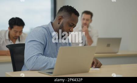 Marketing team using laptop working in company Stock Photo