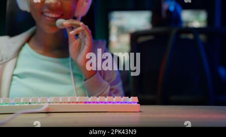 Game streamer using pc setup playing multiplayer first person shooter Stock Photo
