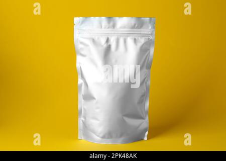One blank foil package on yellow background Stock Photo
