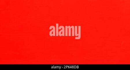Red wall, texture, background. The wooden wall, painted with enamel paint. Flat surface in reddish color. Smooth and glossy surface Stock Photo