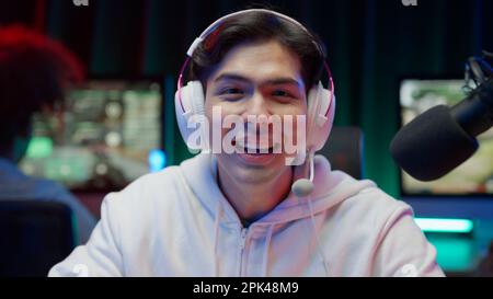 Game streamer using pc setup playing multiplayer first person shooter Stock Photo