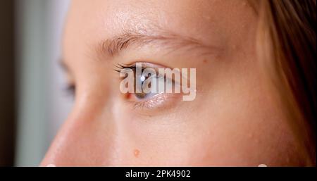 Close up beautiful eyes of young woman looking forward Stock Photo