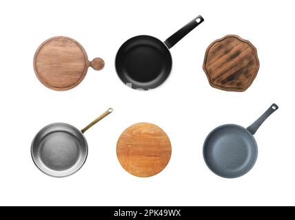 Set with pans and wooden cutting boards on white background, top view Stock Photo