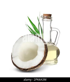 Ripe coconut and pitcher with oil on wooden background Stock Photo - Alamy