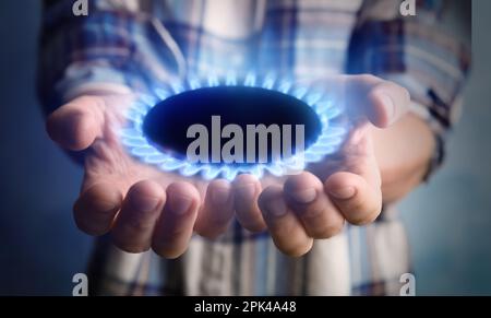 Closeup view of man holding gas burner with blue flame Stock Photo