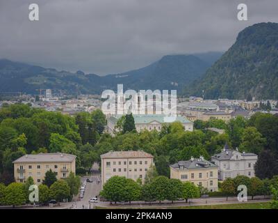 Historic city of Salzburg in summer, Austria. view on Andrae Church Salzburg and Mirabell Palace from other side Salzach river Stock Photo