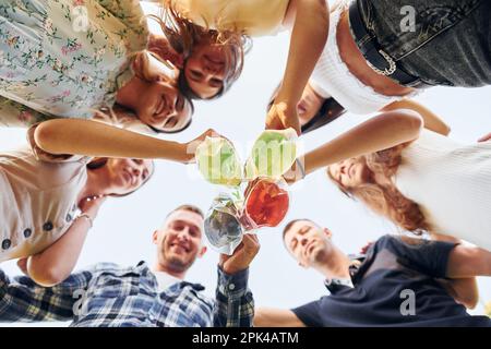 View from below of young positive people that looking down Stock Photo