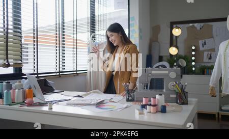 Fashion designer designing new clothes collection working in the fashion studio Stock Photo