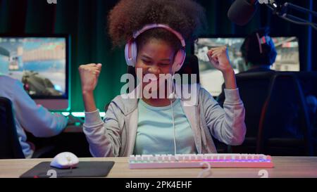 Game streamer using pc setup playing multiplayer first person shooter ...
