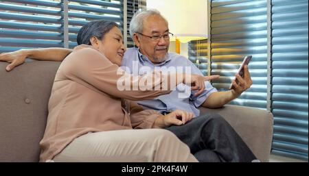 Couple of happy senior people smiling and spending time at home Stock Photo