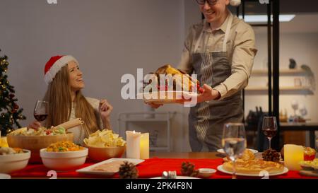 Family celebrating Christmas together eating special food in the dinning room Stock Photo