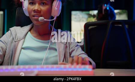 Game streamer using pc setup playing multiplayer first person shooter Stock Photo