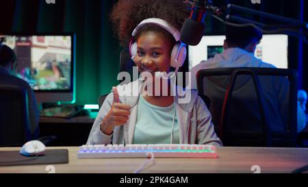 Game streamer using pc setup playing multiplayer first person shooter Stock Photo