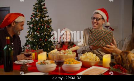 Happy people with Santa hat celebrating Christmas day together Stock Photo