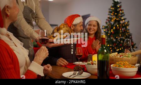 Family celebrating Christmas together eating special food in the dinning room Stock Photo