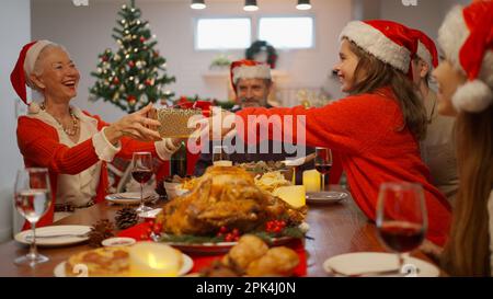 Happy people with Santa hat celebrating Christmas day together Stock Photo