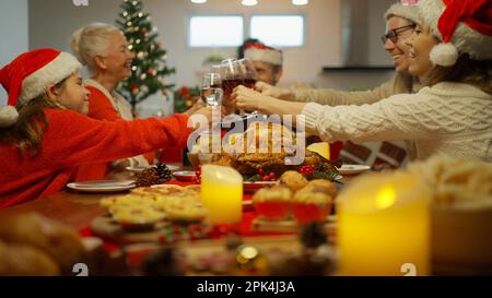 Muti-generation family enjoying with dinner party clinking glasses together Stock Photo