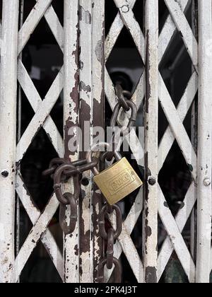 padlock on an old metal fence Stock Photo