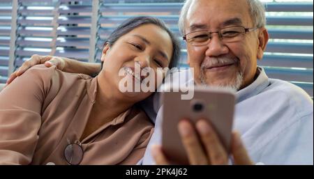 Couple of happy senior people smiling and spending time at home Stock Photo