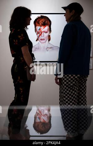 London, UK.  5 April 2023. Visitors view 'Aladdin Sane, Eyes Shut', 1973, by Brian Duffy, at a preview of ‘Aladdin Sane: 50 Years’, a new exhibition at the Royal Festival Hall at the Southbank Centre.  Fifty years on from the release of David Bowie’s ‘Aladdin Sane’ album, the exhibition explores the iconic ‘lightning bolt’ cover portrait by Brian Duffy and the continuous reshaping of Bowie’s image.  The show runs 6 April to 28 May.  Credit: Stephen Chung / Alamy Live News Stock Photo