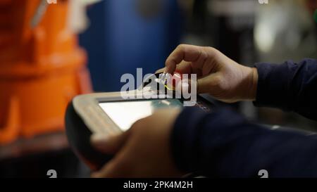 Close up shot of mechanic controlling machine in the factory Stock Photo