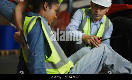 Industrial warehouse staff having accident in the factory Stock Photo