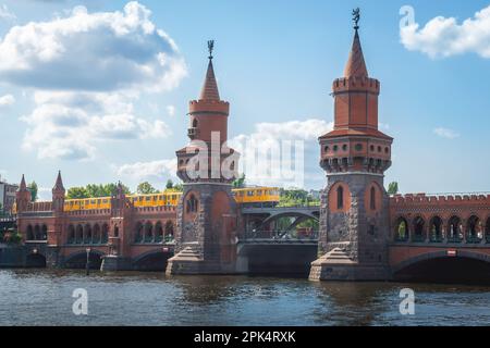 Yellow train at Oberbaum Bridge (Oberbaumbrucke) - Berlin, Germany Stock Photo