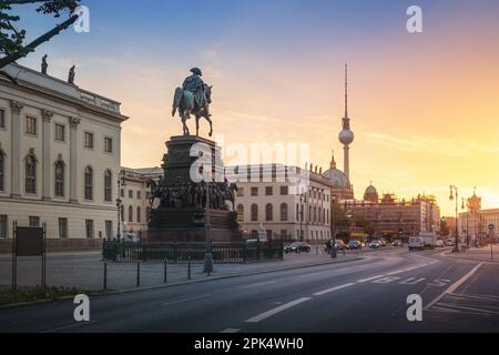 Unter den Linden Boulevard with Frederick the Great Statue and Fernsehturm TV Tower at sunrise - Berlin, Germany Stock Photo