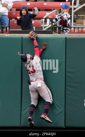 Atlanta Braves center fielder Michael Harris II (23) loses his glasses as  he hits the outfield wall catching a fly ball by St. Louis Cardinals' Paul  Goldschmidt to end the eighth inning