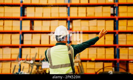 Back view of professional male engineer manager using walkie-talkie controlling Stock Photo