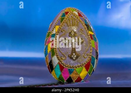 Decorative ceramic egg with a cross decorated in gold accessories Stock Photo