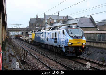 DRS class 88 bi-mode loco 88010, named Aurora, carrying a special livery - Refrigerated Rail... Cool Move - at Carnforth on the WCML 5th April 2023. Stock Photo