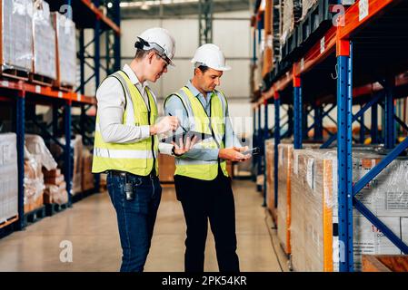 Smart male engineer manager wearing safety vest and helmet using digital tablet Stock Photo