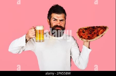 Bearded man with delicious pizza and cup of beer. Restaurant or pizzeria. Fast food. Italian food. Bearded man with tasty pizza and beer. Pizza time Stock Photo