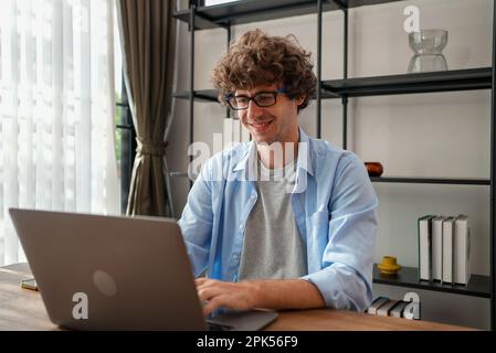 Happy businessman using laptop sending email working at home Stock Photo