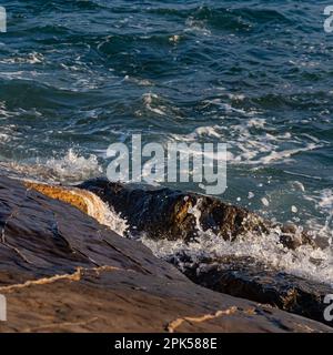 Sea waves on rocks Stock Photo