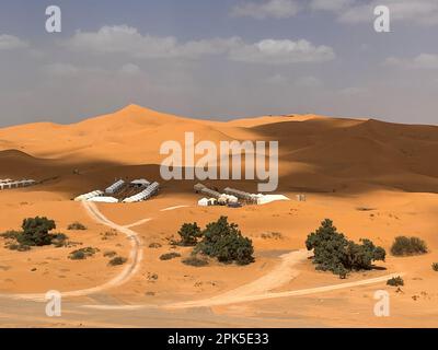 Merzouga, Morocco, Africa: panoramic road in the Sahara desert with the beautiful sand dunes, palm trees and tented camps, 4x4 trip, Erg Chebbi dunes Stock Photo