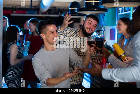 Young people are resting on the corporate event in bar Stock Photo